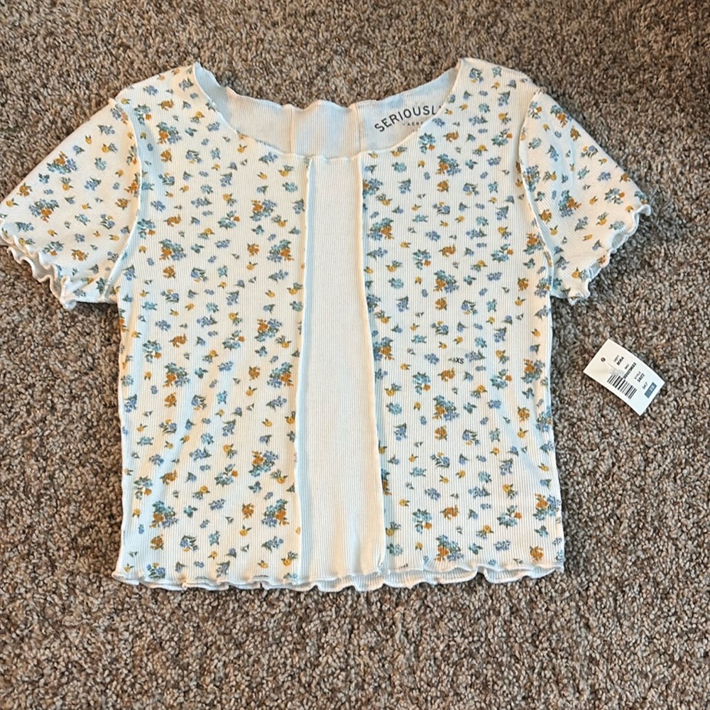 Short sleeve ruffle end baby tee. Floral design with inside out hemming style.